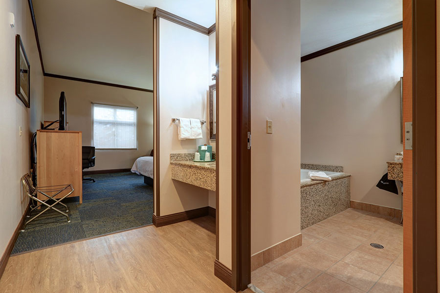 guest room with king bed and jetted tub