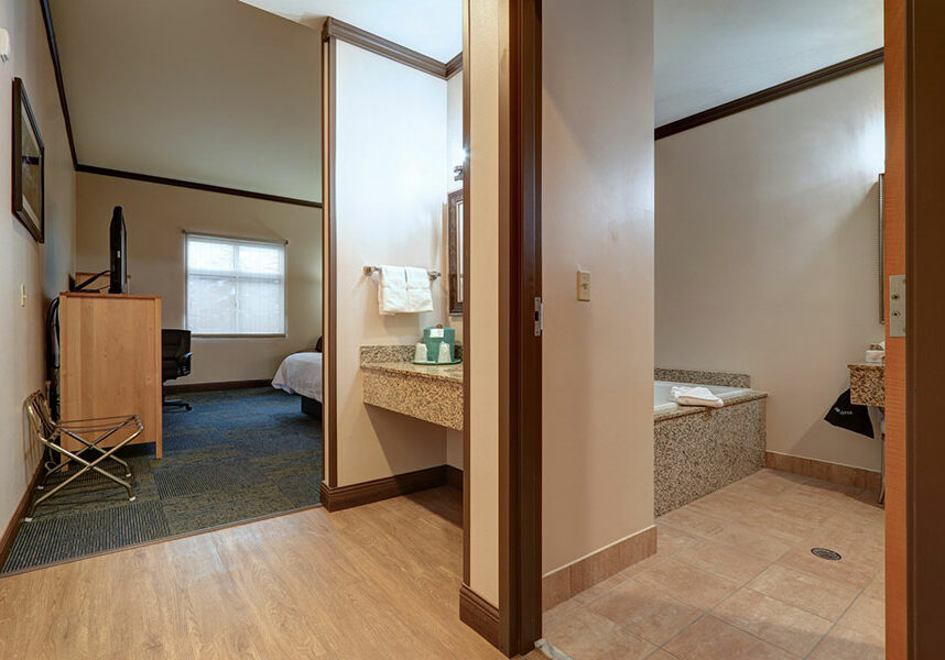 guestroom with one king bed and whirlpool tub